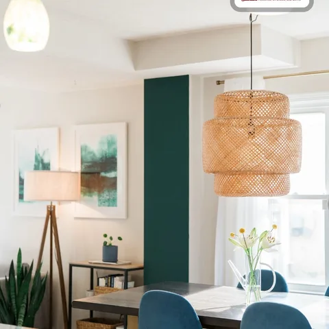 That rattan pendant light isn't just pretty, it's doing a lot of work. 🪴