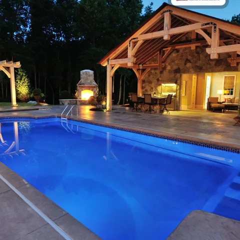 A pool after dark with a fireplace going might be the peak of summer living. 🔥🌊