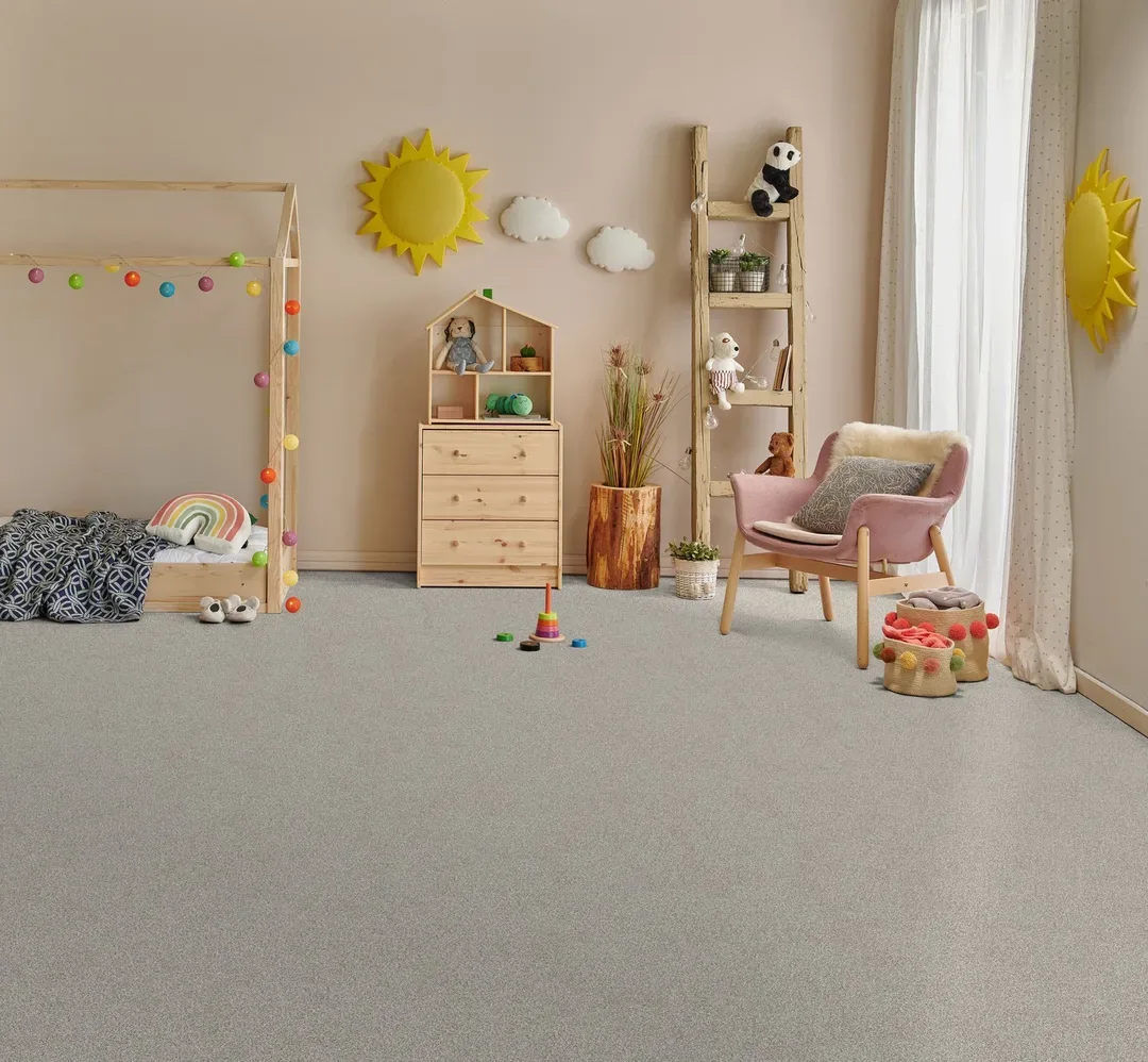 Gray carpet beside a house-frame child’s bed and play area